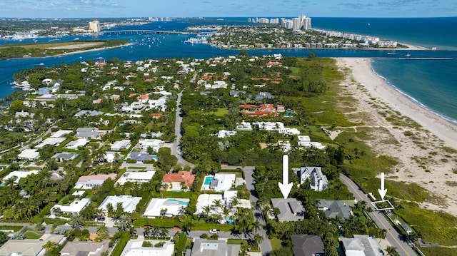 birds eye view of property featuring a water view, a residential view, and a view of the beach