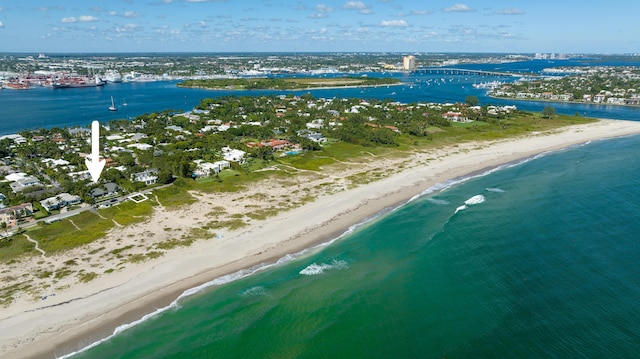 bird's eye view with a water view and a beach view