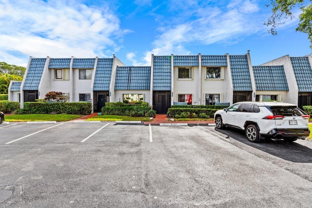 view of property featuring uncovered parking