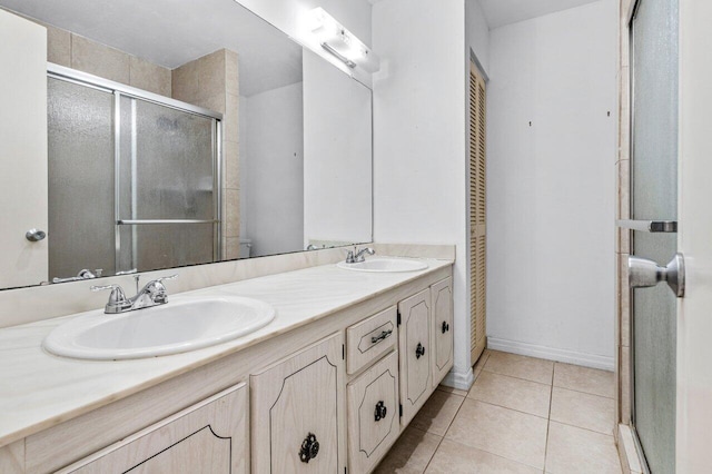 full bathroom with a closet, tile patterned flooring, and a sink