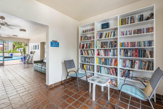 living area featuring built in shelves and baseboards