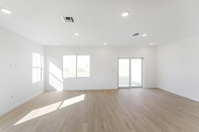 unfurnished room featuring recessed lighting, visible vents, and light wood-style floors