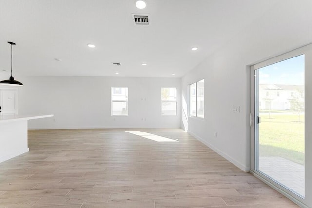 unfurnished room with light wood-style flooring, visible vents, baseboards, and recessed lighting