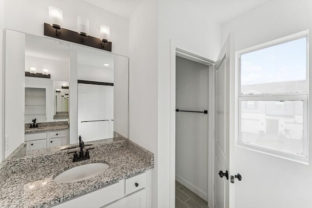 full bath with two vanities and a sink