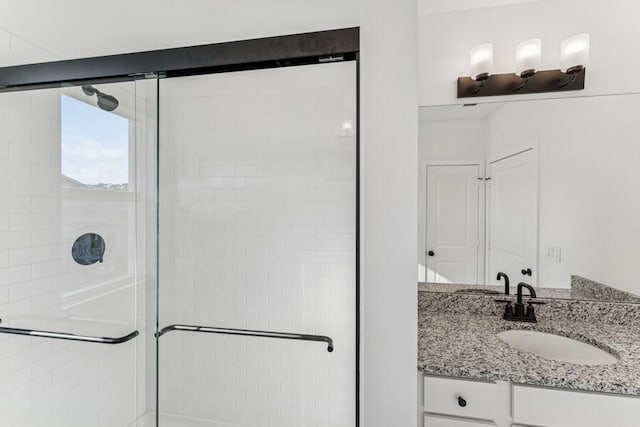 bathroom with a stall shower and vanity