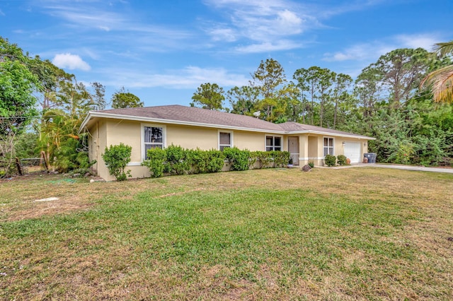 ranch-style home featuring a front lawn, fence, an attached garage, and stucco siding