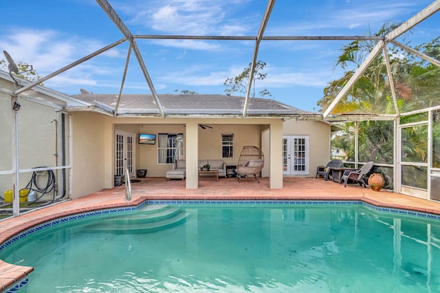 outdoor pool featuring french doors, a patio area, and a lanai