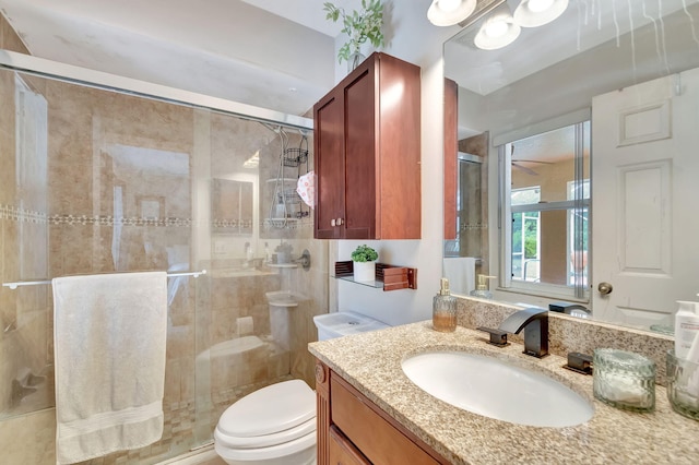 full bath featuring toilet, a shower stall, and vanity