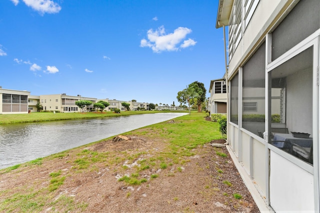 view of yard with a residential view and a water view