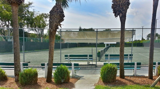 view of tennis court featuring fence