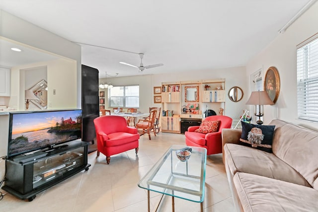 living area with light tile patterned floors and a ceiling fan