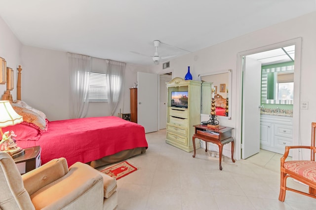 bedroom with visible vents, a sink, connected bathroom, and a ceiling fan