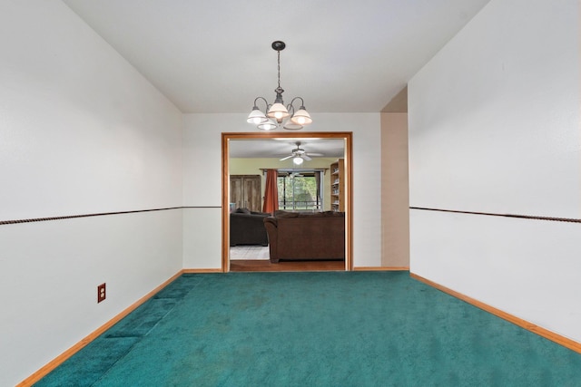 carpeted empty room featuring baseboards and a notable chandelier