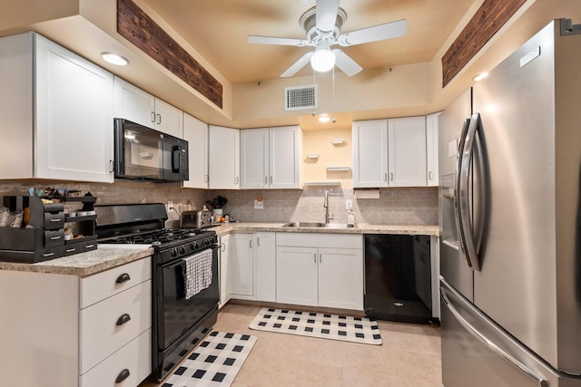 kitchen with a sink, white cabinetry, visible vents, decorative backsplash, and black appliances