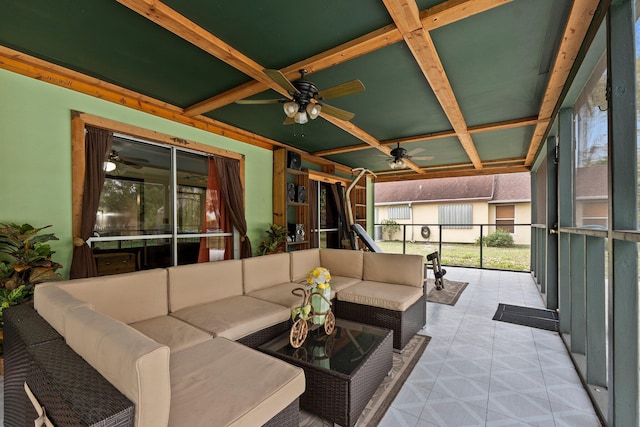 sunroom featuring a ceiling fan, coffered ceiling, and beamed ceiling