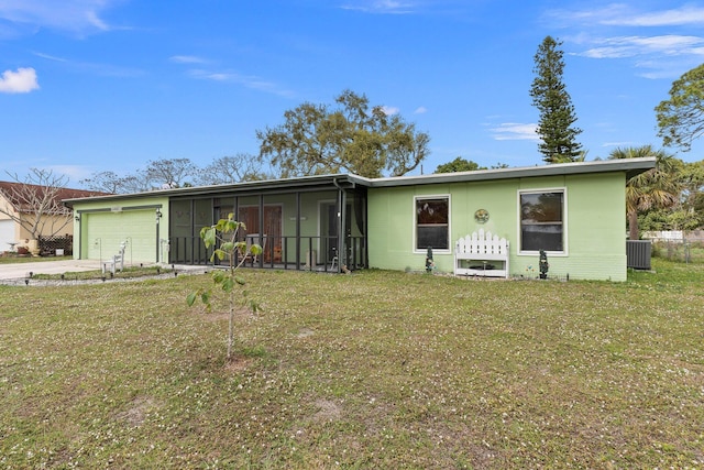 ranch-style home with an attached garage, central air condition unit, a sunroom, driveway, and a front yard