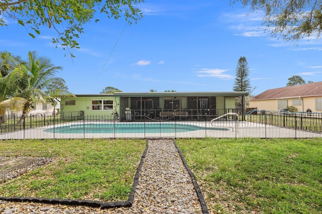 view of pool featuring a fenced in pool, a sunroom, fence, and a lawn