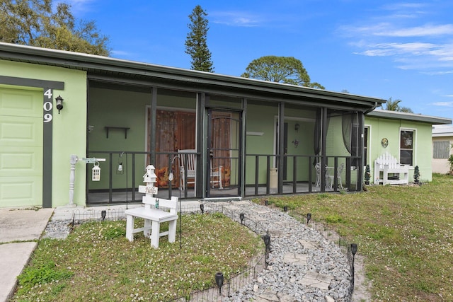 rear view of property with a garage