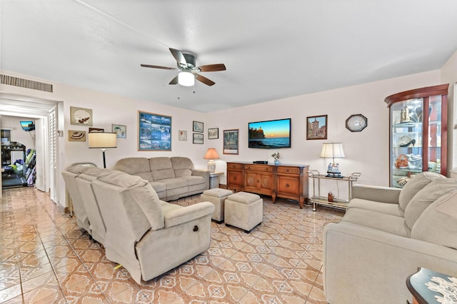 living area with ceiling fan and visible vents