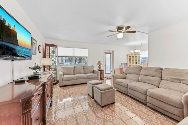 living area featuring ceiling fan with notable chandelier