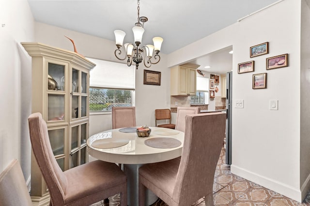 dining space with a chandelier and baseboards