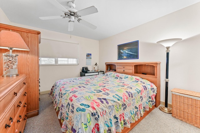 bedroom with a ceiling fan and baseboards