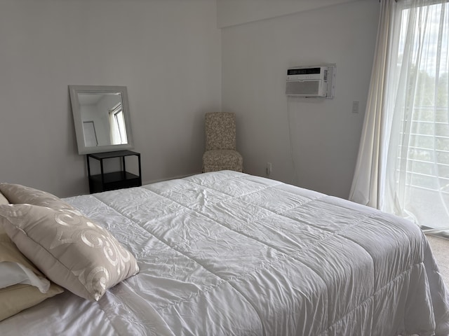 bedroom with an AC wall unit