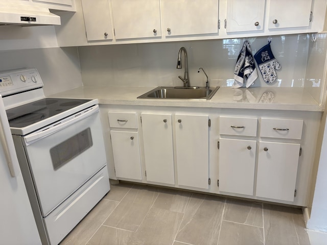 kitchen featuring white electric range oven, light countertops, under cabinet range hood, white cabinetry, and a sink