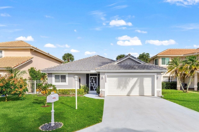 view of front of property featuring a front yard, concrete driveway, and an attached garage