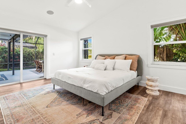 bedroom featuring vaulted ceiling, access to outside, dark wood-type flooring, and baseboards