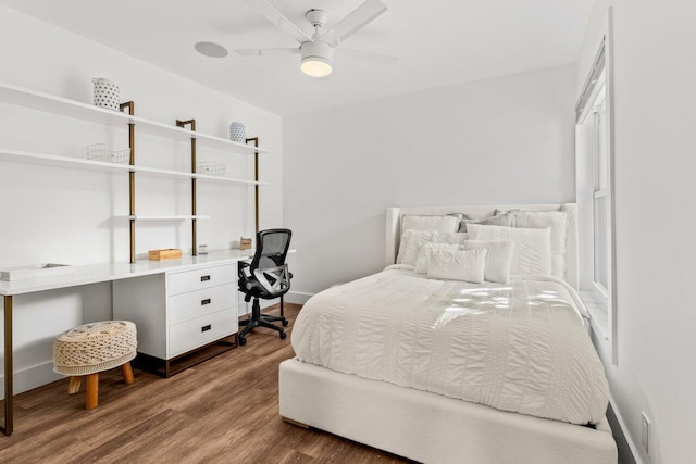 bedroom with a ceiling fan, dark wood-style flooring, and baseboards