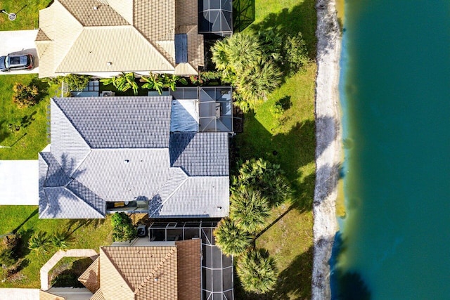 birds eye view of property with a water view and a beach view