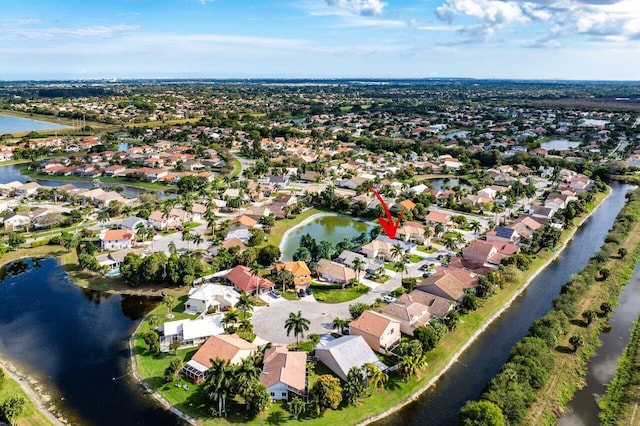 birds eye view of property with a residential view and a water view