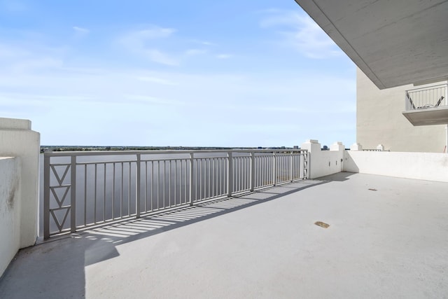 view of patio featuring a gate and a water view