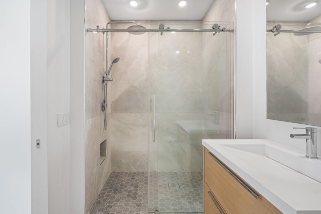 full bathroom with a stall shower, vanity, and recessed lighting