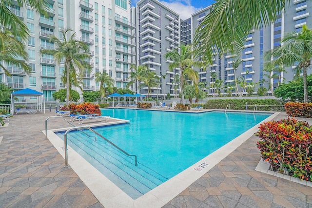 pool featuring fence and a patio