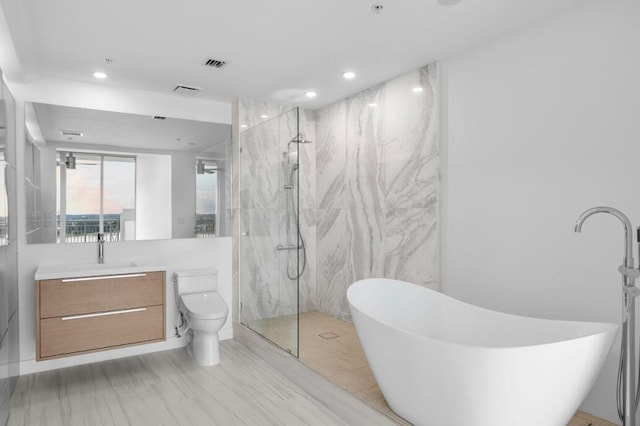 bathroom with a soaking tub, a marble finish shower, visible vents, and vanity