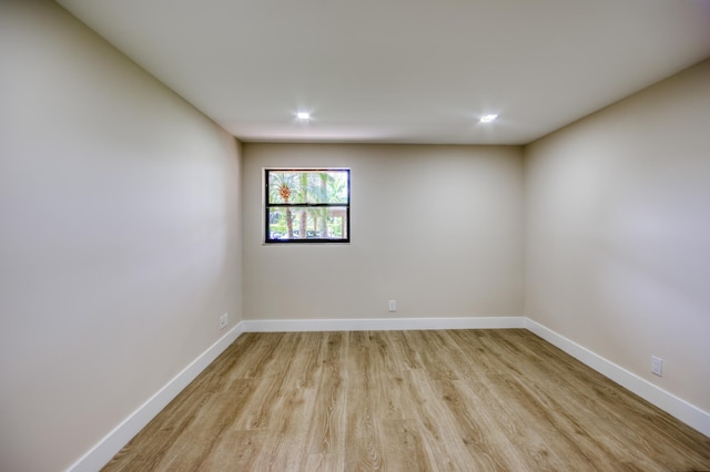 unfurnished room with recessed lighting, light wood-style flooring, and baseboards