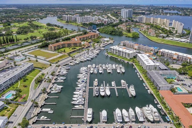 birds eye view of property with a view of city and a water view