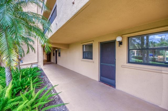 doorway to property with a patio area and stucco siding