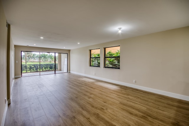 unfurnished room featuring recessed lighting, baseboards, and light wood finished floors