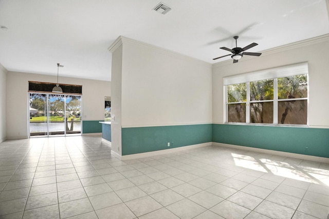 spare room with ornamental molding, light tile patterned flooring, visible vents, and baseboards