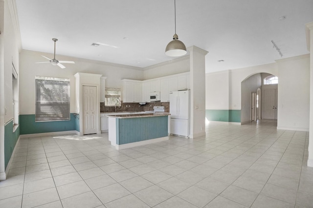 kitchen featuring white appliances, arched walkways, white cabinets, ceiling fan, and open floor plan