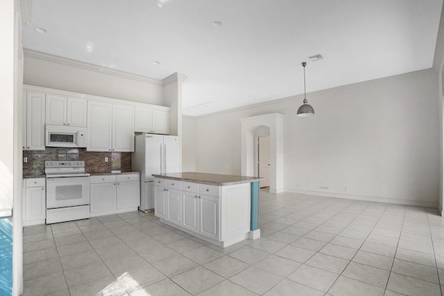 kitchen with white appliances, tasteful backsplash, light tile patterned floors, white cabinets, and crown molding