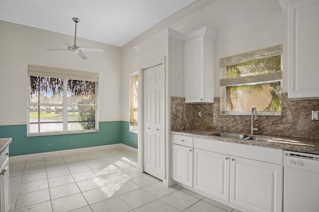 kitchen with a sink, a ceiling fan, white cabinets, dishwasher, and crown molding