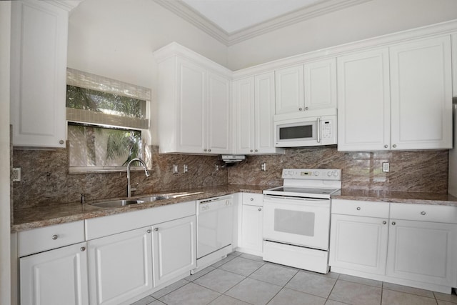 kitchen featuring white appliances, light tile patterned floors, white cabinets, ornamental molding, and a sink