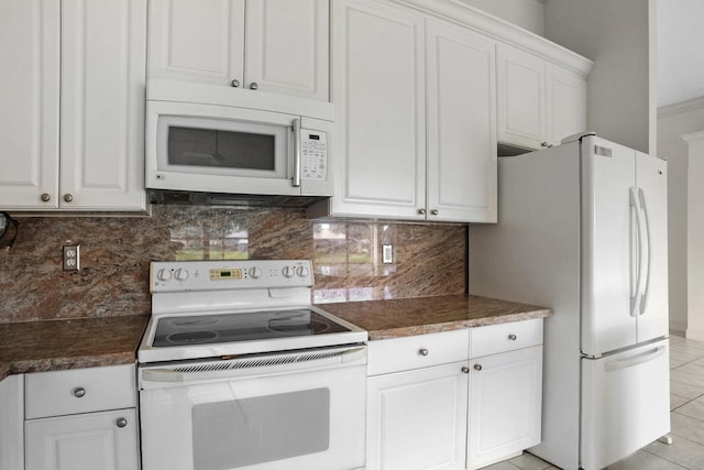 kitchen with dark countertops, white appliances, white cabinets, and decorative backsplash