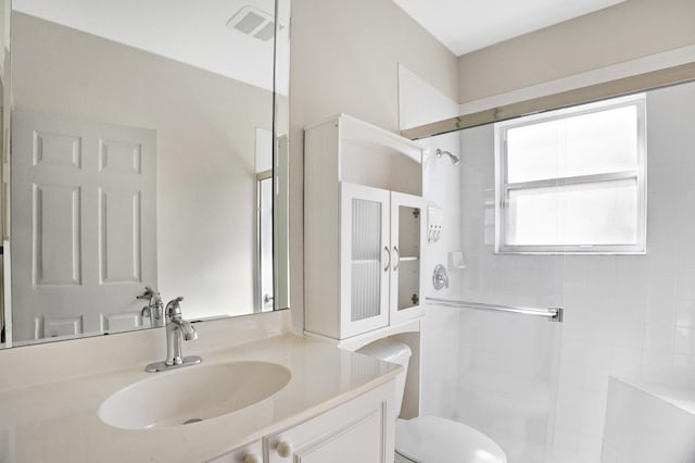 full bath with visible vents, toilet, a stall shower, and vanity