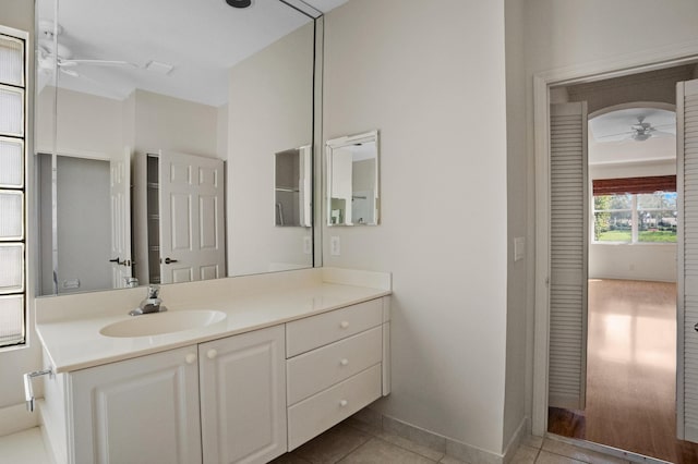 bathroom featuring a ceiling fan, vanity, baseboards, and tile patterned floors