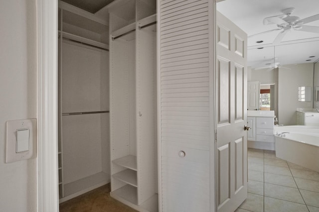 spacious closet with ceiling fan and light tile patterned floors